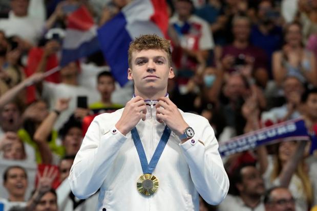 FILE - Leon Marchand of France, reacts after receiving his gold medal for the men's 200-meter individual medley final at the 2024 Summer Olympics, Friday, Aug. 2, 2024, in Nanterre, France. (AP Photo/Natacha Pisarenko, FIle)