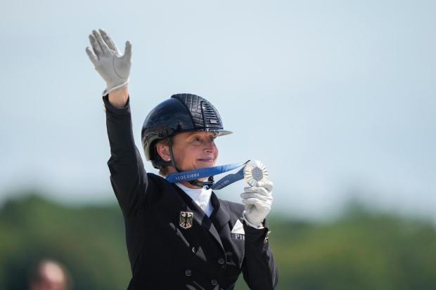 FILE - Germany's Isabell Werth reacts after winning silver medal during the dressage Individual Grand Prix Freestyle, at the 2024 Summer Olympics, Sunday, Aug. 4, 2024, in Versailles, France. (AP Photo/Mosa'ab Elshamy, File)