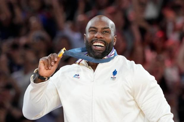 FILE - Golden medalist France's Teddy Riner poses on the podium of the judo men's +100 kg event in the team judo competition, at Champ-de-Mars Arena, during the 2024 Summer Olympics, Friday, Aug. 2, 2024, in Paris, France. (AP Photo/Eugene Hoshiko, File)