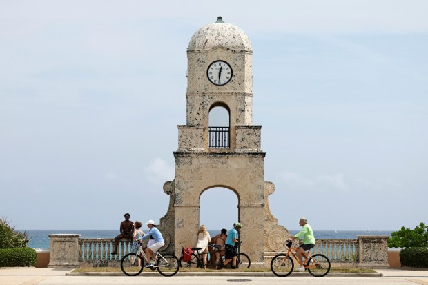 Beachgoers visit the Worth Avenue Clock Tower in Palm Beach. (John McCall/South Florida Sun Sentinel)