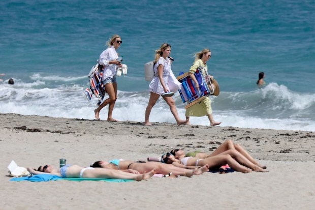 People soak up the sun in Palm Beach, Saturday, March 9, 2024. (John McCall/South Florida Sun Sentinel)