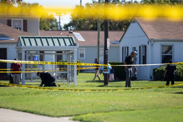Officials work the scene of a shooting in the 1200 block of 16th St. near the Stuart Gardens apartments in Newport News that left a 15-year-old Menchville student dead on Tuesday, Sept. 10, 2024. According to police, a ShotSpotter alert prompted officers to go to the area just after 6:15 a.m. where the student was then located. (Kendall Warner / The Virginian-Pilot)