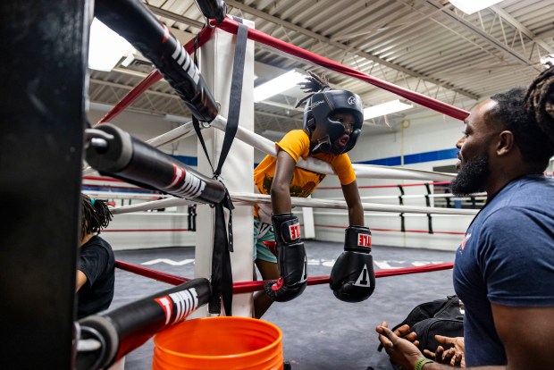 Jesse Smith IV gets a pep talk from his dad before starting his boxing rounds during practice at the Park Place Community Center on Thursday, Sept. 12, 2024. (Kendall Warner / The Virginian-Pilot)