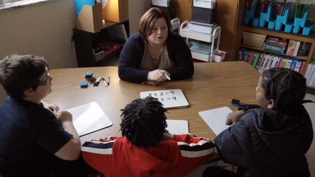 Teacher Kaitlyn Pait-Fulcher works with students in her Modern Classrooms Project math class at Western Branch Middle School. (Courtesy of Chesapeake Public Schools)