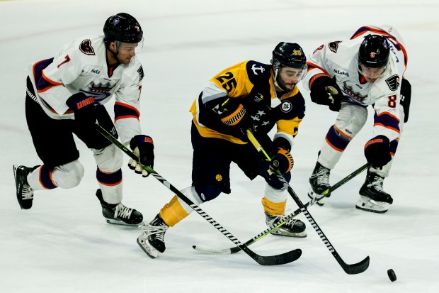 Norfolk Admirals forward Brandon Osmundson tries to handle the puck between Reading's Jacques Bouquet, left, and Powell Connor on Pucks and Paws Night at the Scope Arena in Norfolk, Virginia, on April 3, 2024. (Billy Schuerman / The Virginian-Pilot)