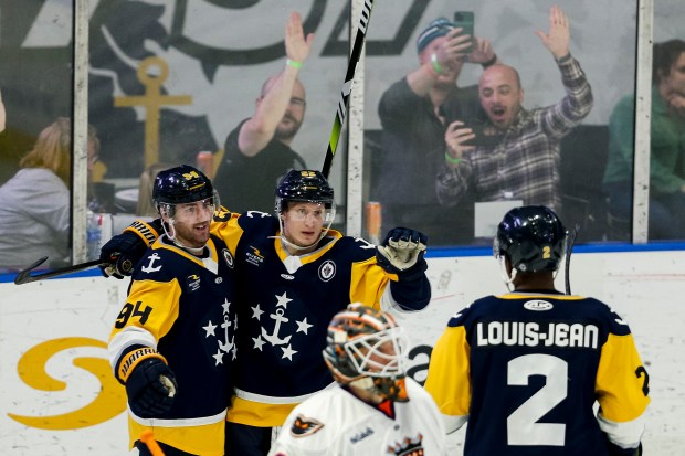 Norfolk Forward Stepan Timofeyev (22), center, is greeted by teammates Brady Fluent (94) and Darick Louis-Jean (2) after Timofeyev's goal in the second period. The Norfolk Admirals faced the Reading Royals on Pucks and Paws Night at the Scope Arena in Norfolk, Virginia, on April 3, 2024. (Billy Schuerman / The Virginian-Pilot)